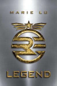 Legend by Marie Lu cover shows a gold seal with a star and three stripes on either side of it like wings above a circle with three bars across its center and an "R" in the middle.
