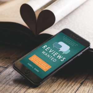 Reviews Wanted Ebook displayed on phone next to open book.