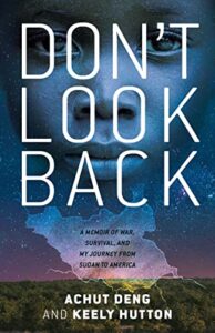 Don't Look Back: A Memoir of War, Survival, and My Journey to America by Achut Deng and Keely Hutton cover shows a landscape with a sky barely at sunrise. Over that is an image of a girl's face so that the sky shows through it.