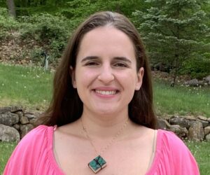 Author Samantha Picaro. Credit Samantha Picaro.
Image shows a smiling woman in a pink blouse with a necklace shaped like a book.