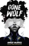Gone Wolf by Amber McBride cover shows a girl with curly hair and dark skin. A pair of light-skinned hands cover her eyes. The eyes of a wolf appear over her collar bones.